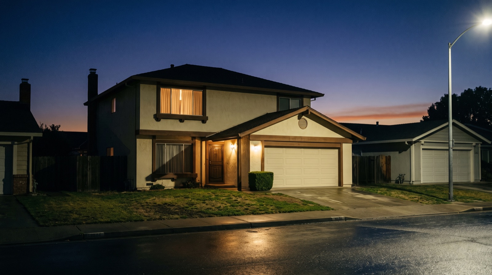 An ordinary Bay Area house at dusk with one light on — a homeowner whose mortgage forbearance has ended