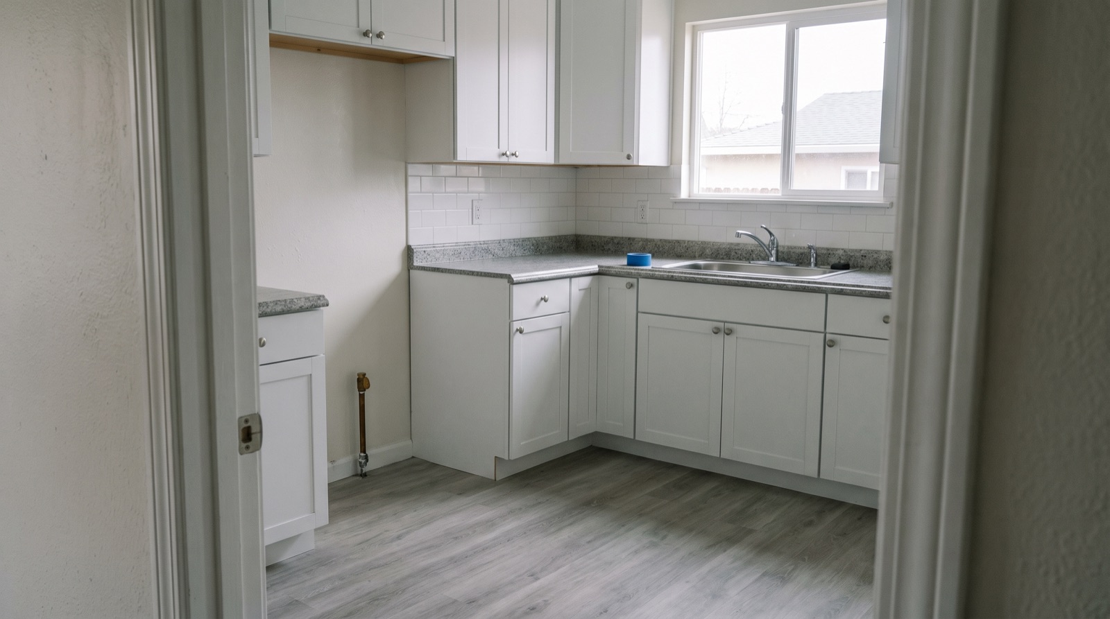 An empty, freshly renovated kitchen in an ordinary Bay Area house — the resale end of the iBuyer model Opendoor reviews describe